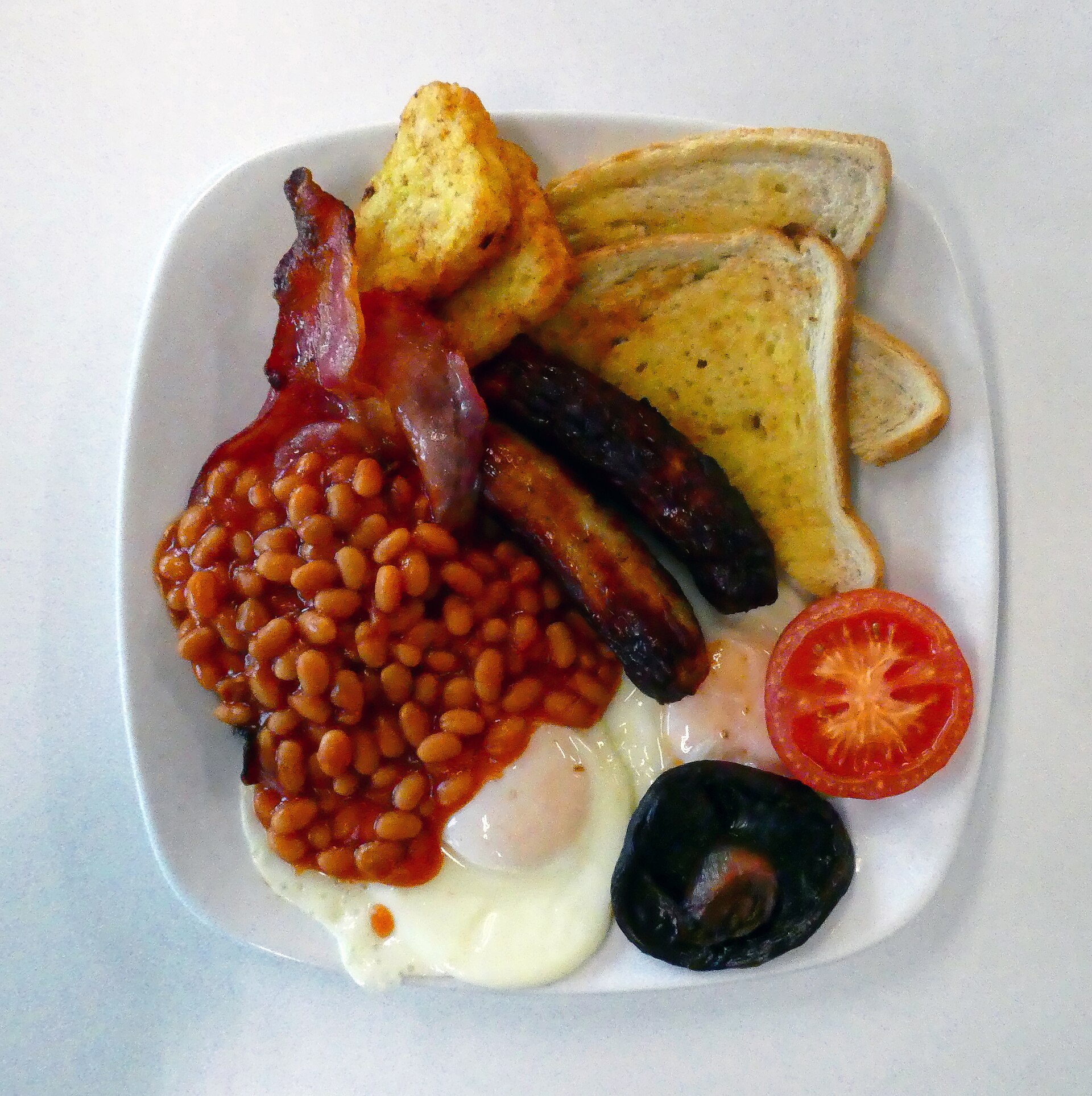 Big breakfast with eggs, bacon, sausage, beans and toast